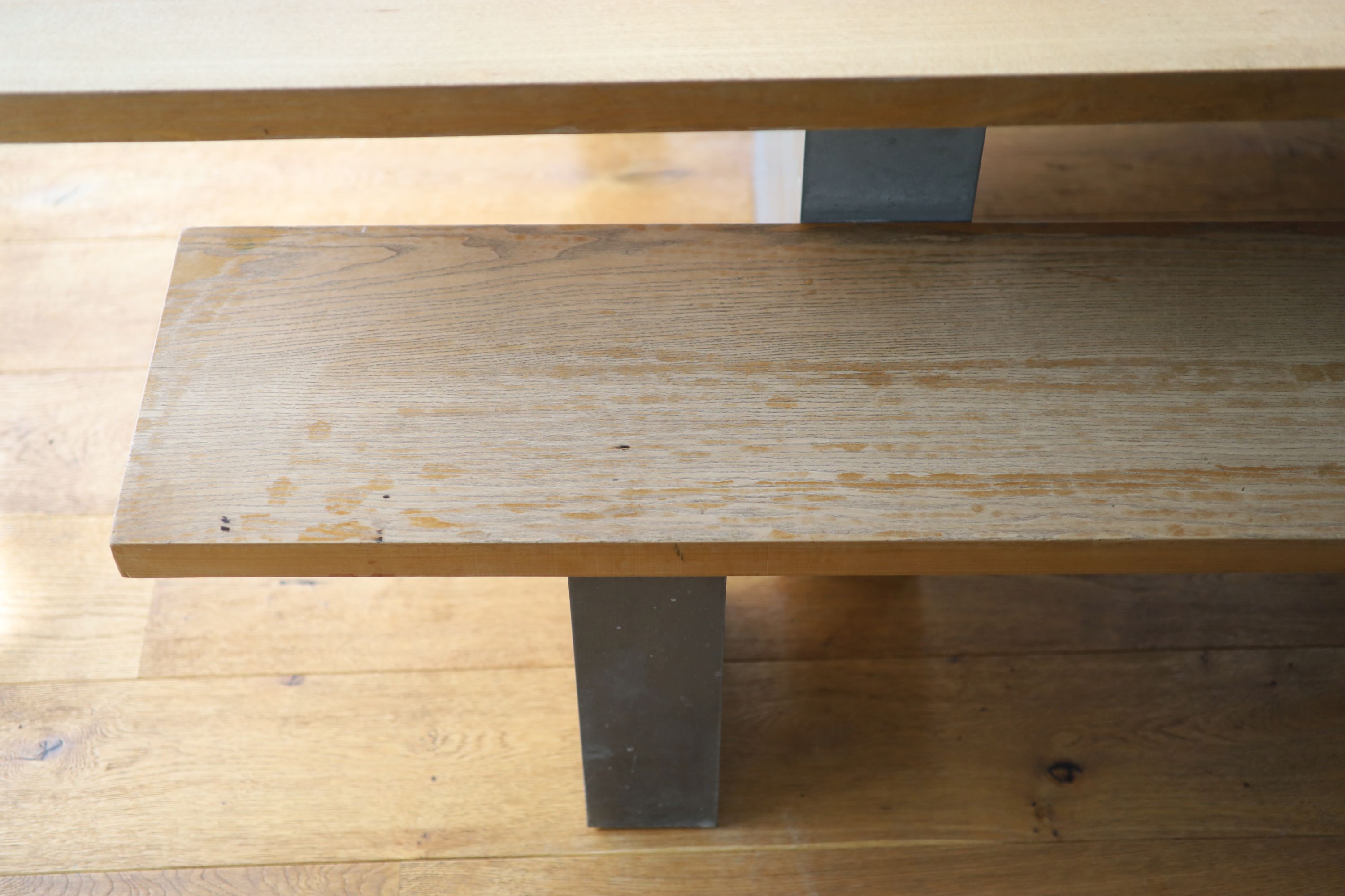 A contemporary oak kitchen table with pair of matching benches and oxidised metal supports, table width 230cm depth 90cm height 74cm, benches width 180cm